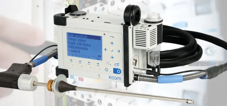 Portable flue gas analyzer device with probe and digital display used for industrial boiler emissions testing.